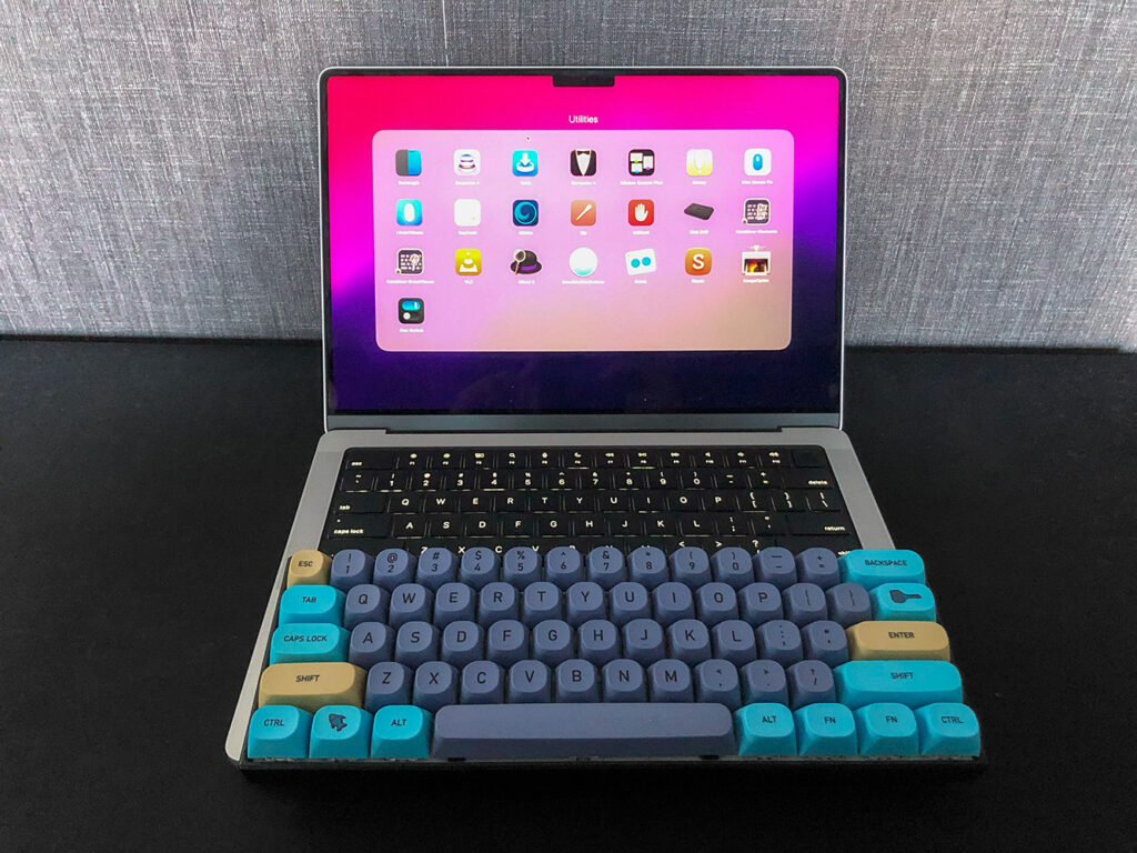 MacBook Air With Keyboard And Utility Apps On The Table