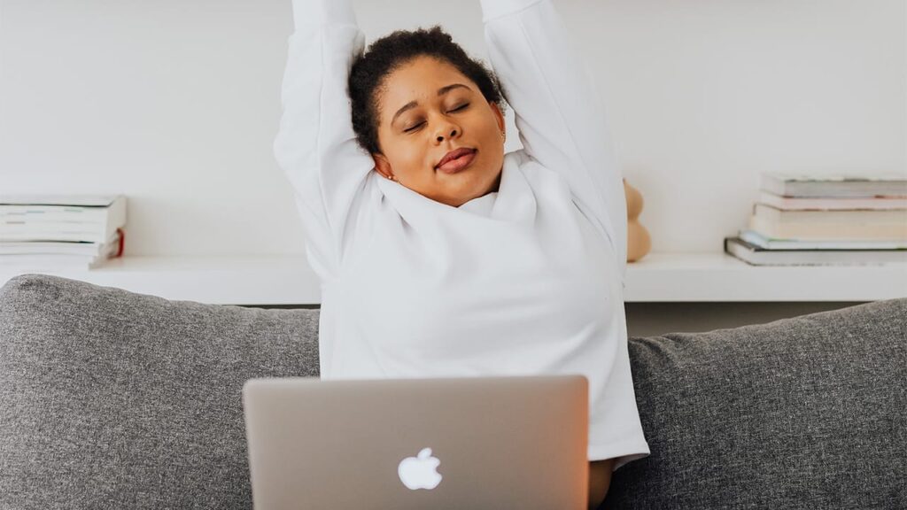 Woman stretching when editing
